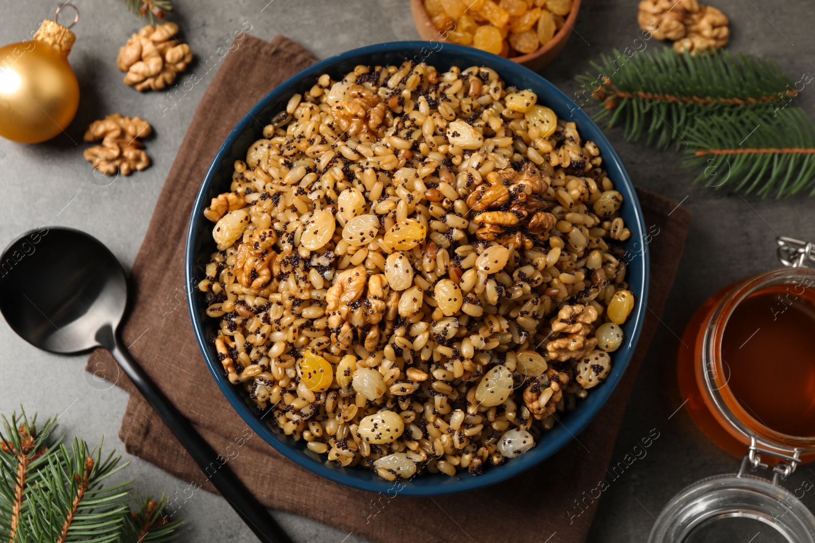 Photo of Traditional Christmas slavic dish kutia served on grey table, flat lay