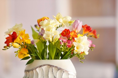 Photo of Beautiful bouquet of freesia flowers on blurred background