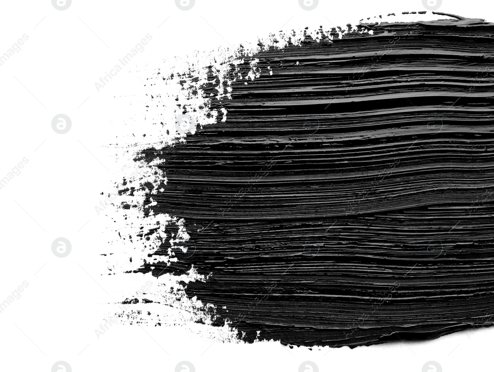 Photo of Brushstrokes of black oil paint on white background, top view