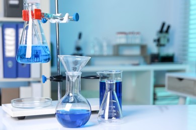 Laboratory analysis. Different glassware and stand on white table indoors