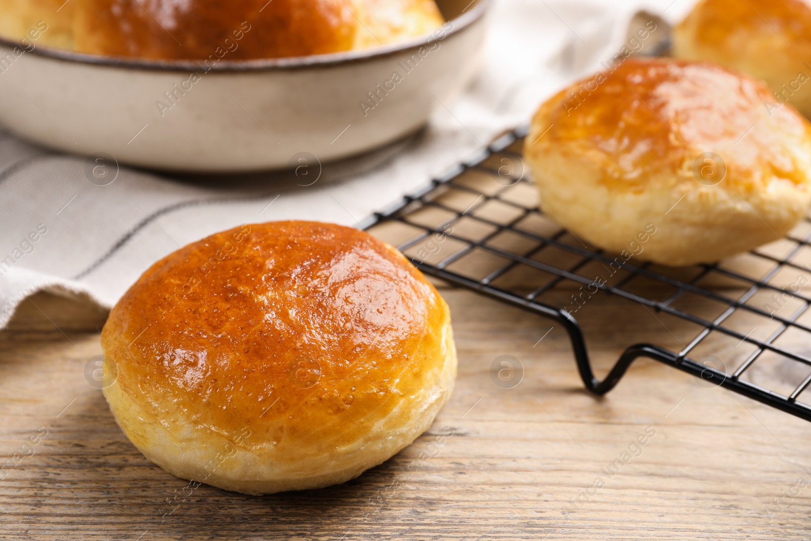 Photo of Tasty scones prepared on soda water on wooden table, closeup