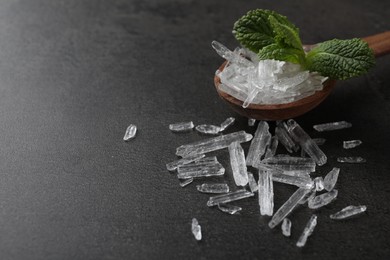 Photo of Menthol crystals and mint leaves on grey background. Space for text