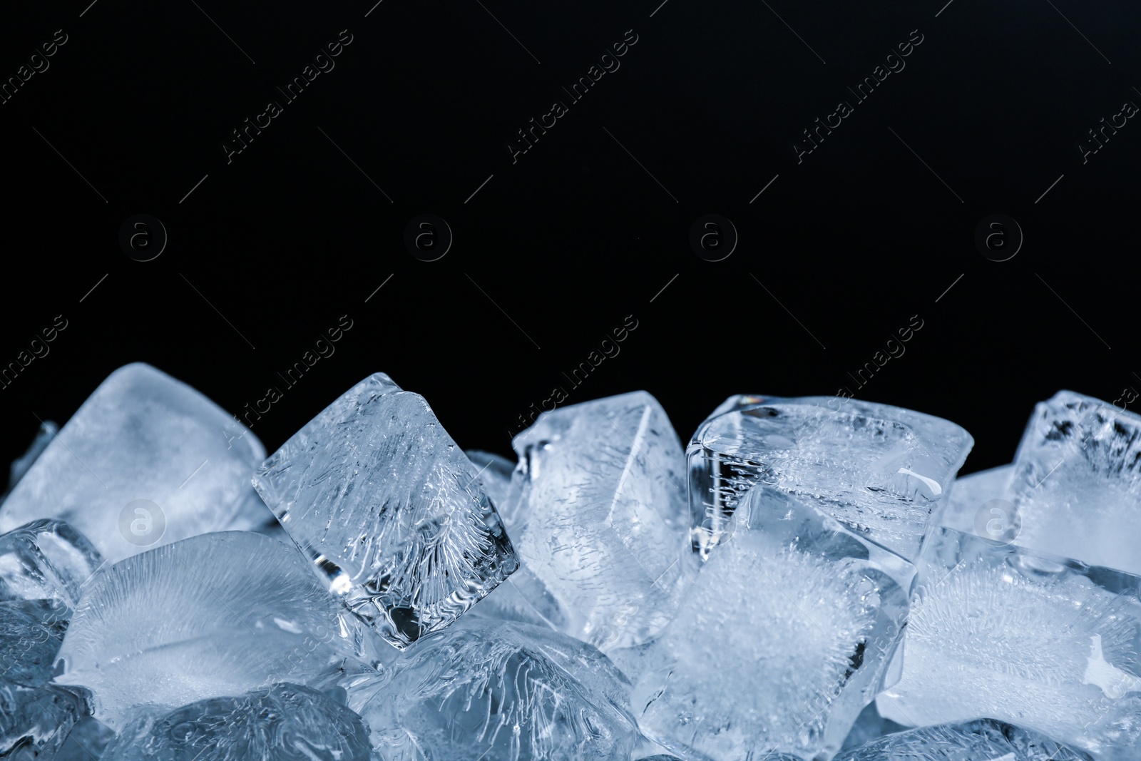 Photo of Ice cubes on black background, closeup view