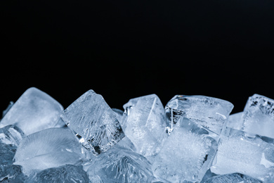 Photo of Ice cubes on black background, closeup view