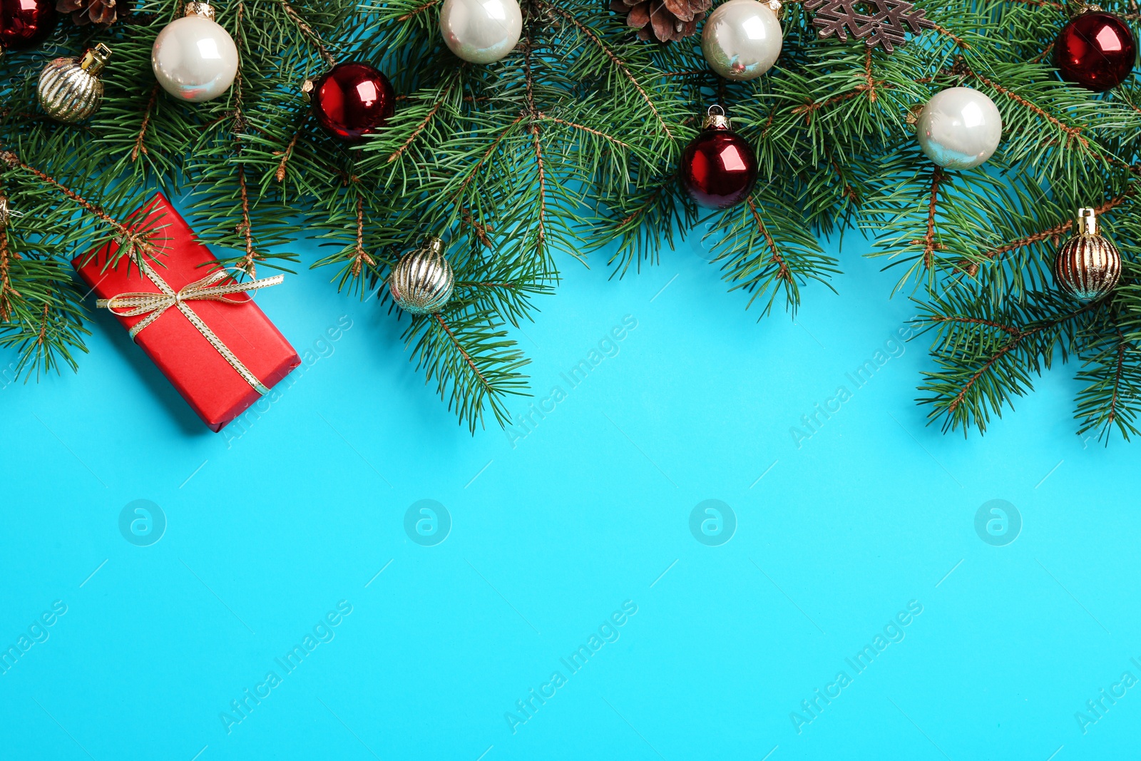 Photo of Flat lay composition with Christmas decor on light blue background. Space for text