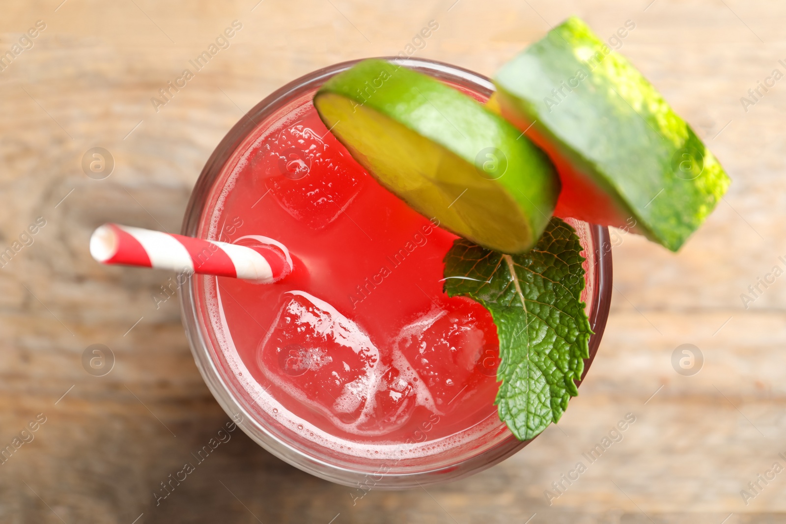 Photo of Delicious fresh watermelon drink on wooden table, top view