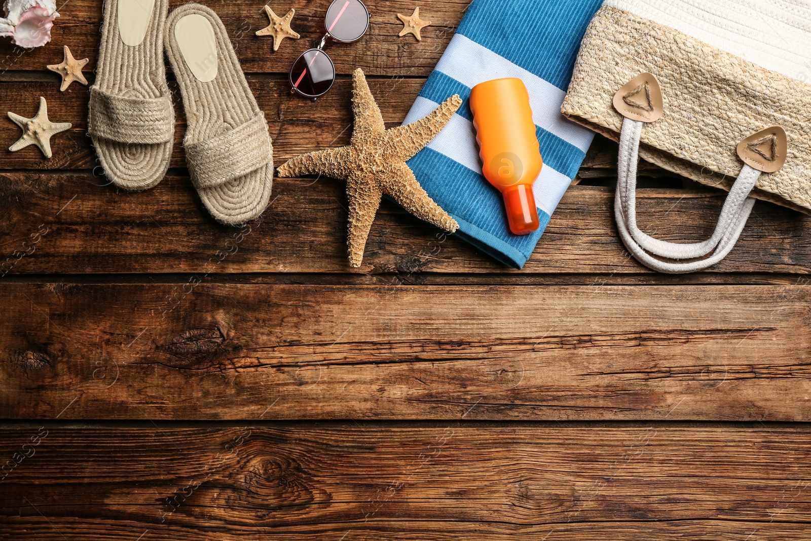 Photo of Beach accessories on wooden background, flat lay. Space for text