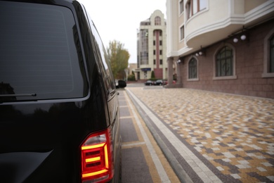 Photo of Black delivery van parked on street near building