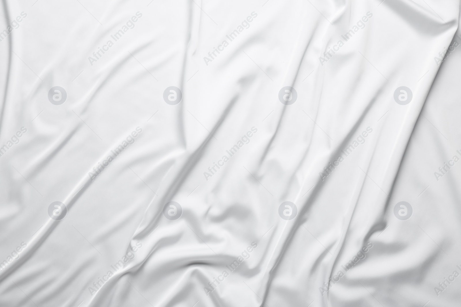 Photo of Texture of white silk ripple fabric as background, top view