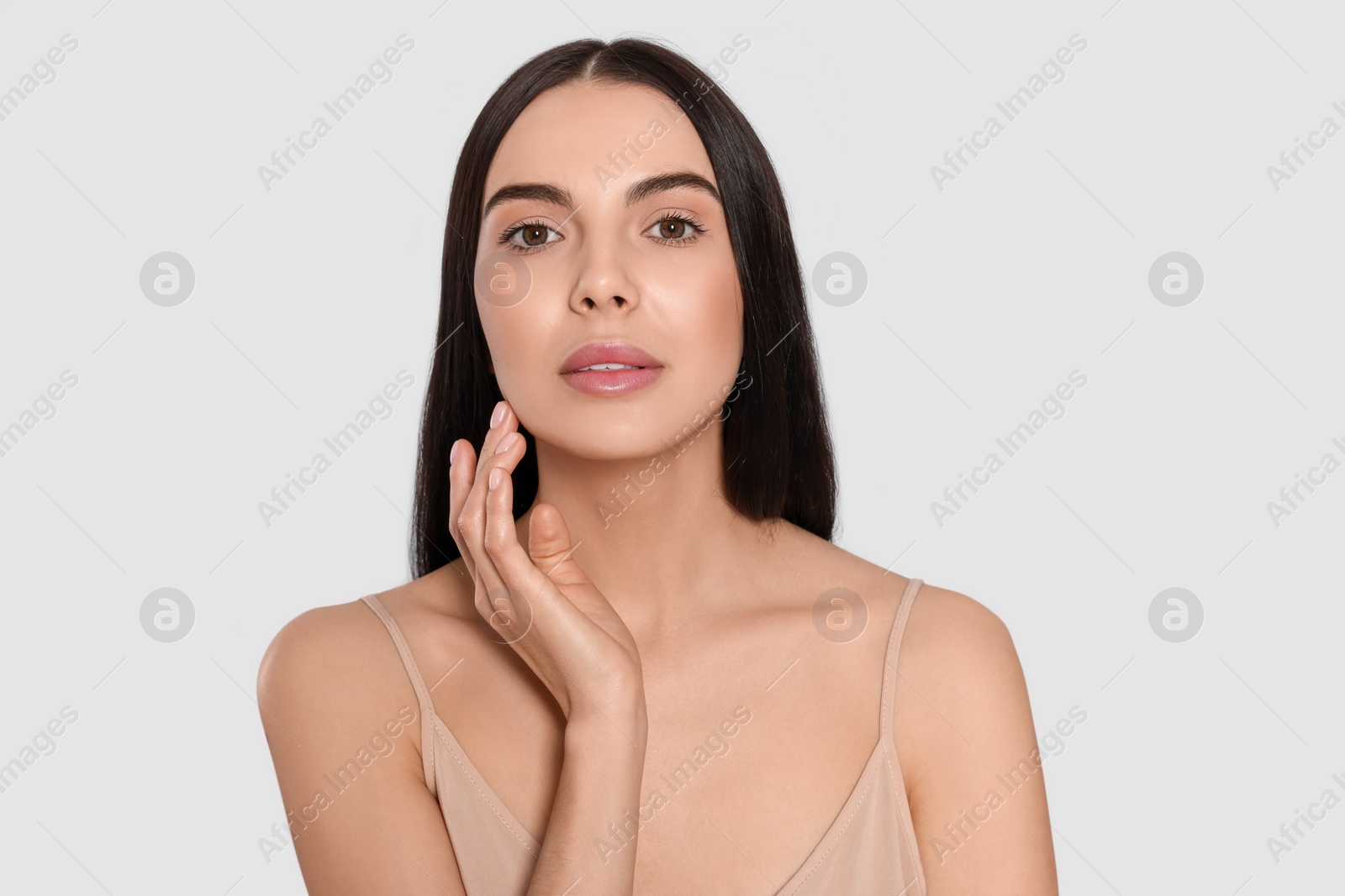 Photo of Portrait of attractive young woman on light grey background. Spa treatment