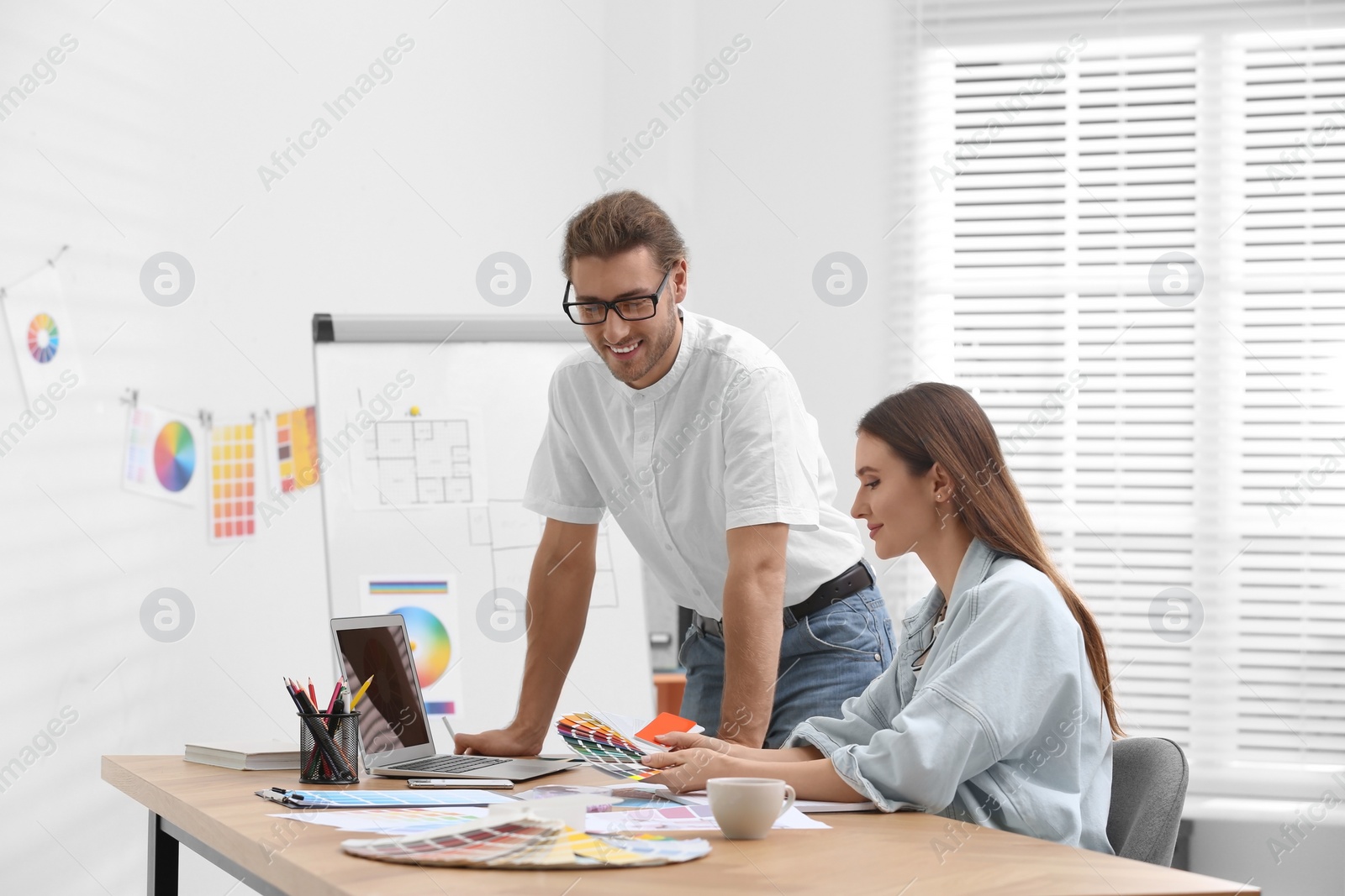 Photo of Professional interior designer with colleague working in office