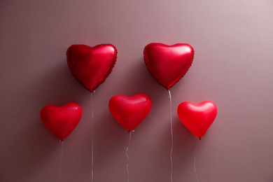 Photo of Colorful heart shaped balloons on brown background. Valentine's day celebration