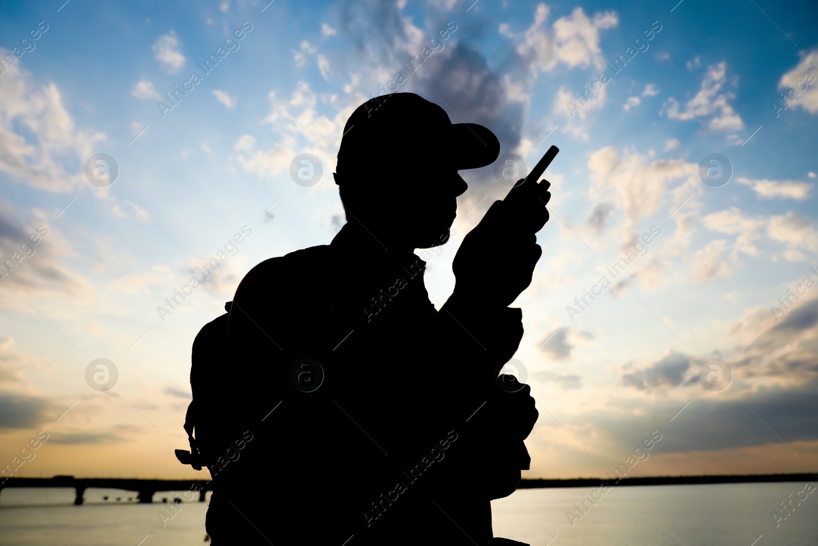 Photo of Soldier with portable radio transmitter outdoors. Military service