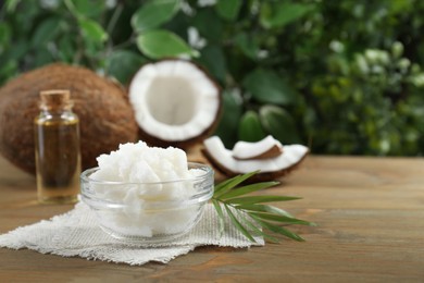 Organic coconut cooking oil on wooden table. Space for text