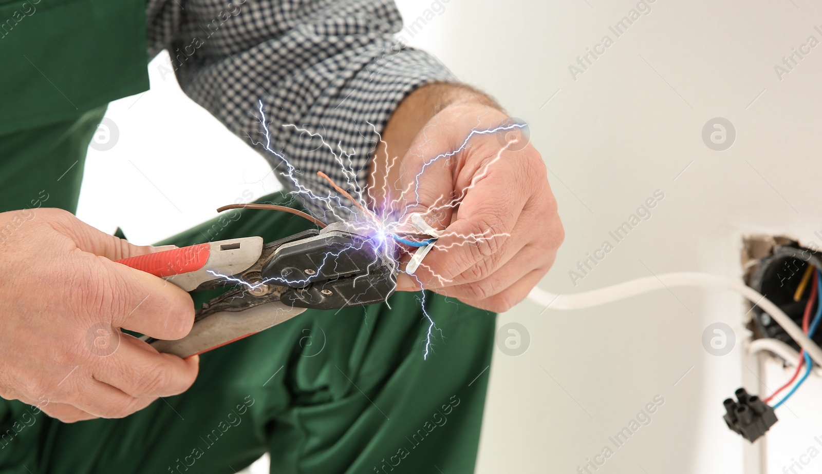 Image of Electrician receiving electric shock while working, closeup