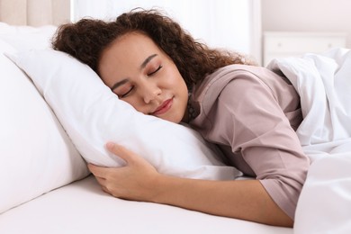 Photo of Beautiful African American woman sleeping in bed at home