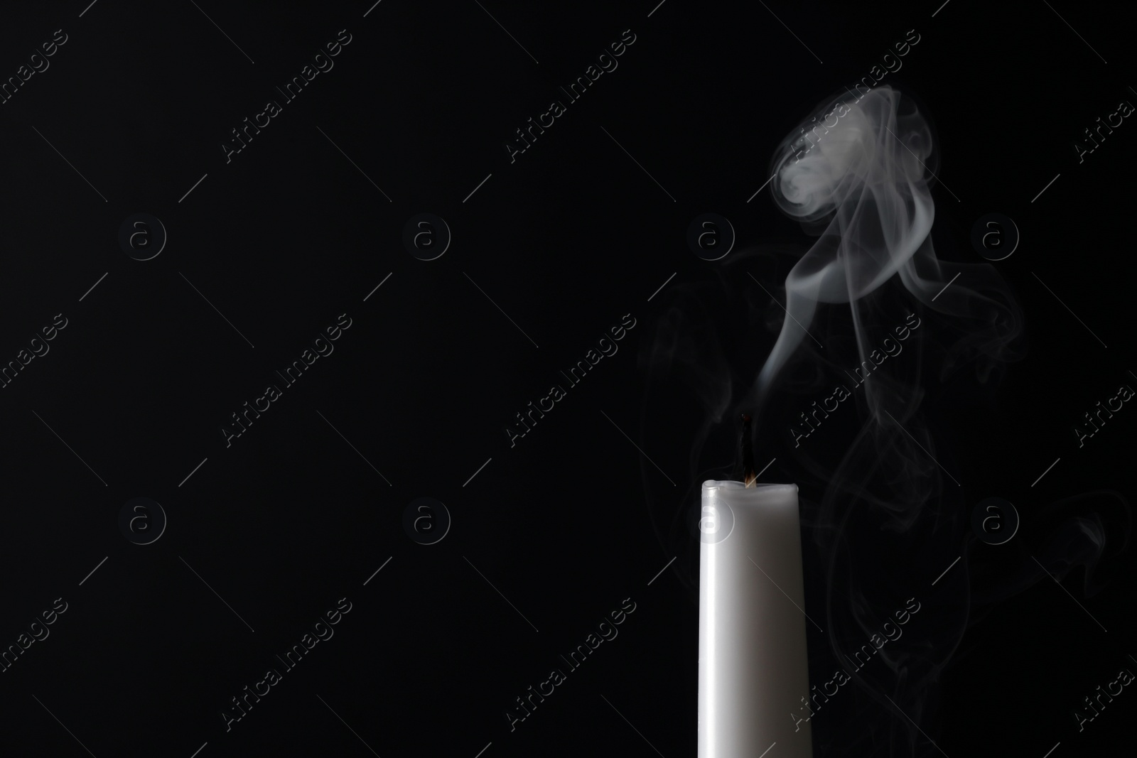 Photo of Smoldering candle wick and smoke on dark background, space for text