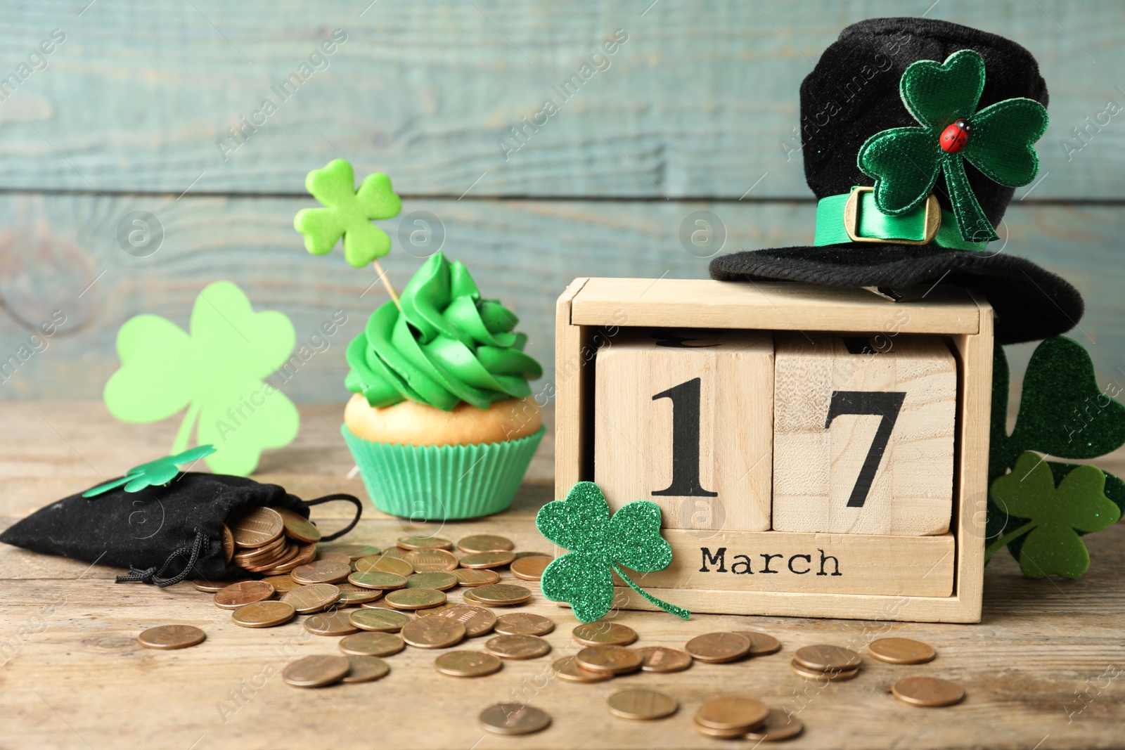 Photo of Composition with block calendar on wooden table. St. Patrick's Day celebration