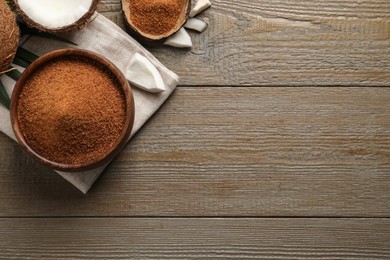 Photo of Flat lay composition with natural coconut sugar on wooden table, space for text