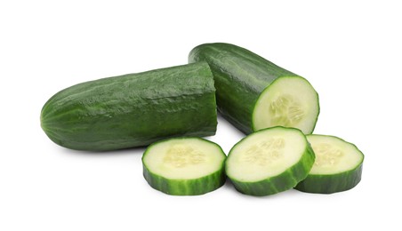 Photo of Halves and slices of long cucumber isolated on white