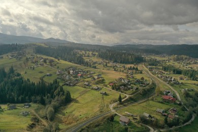 Photo of Aerial view of beautiful forest and mountain village on autumn day