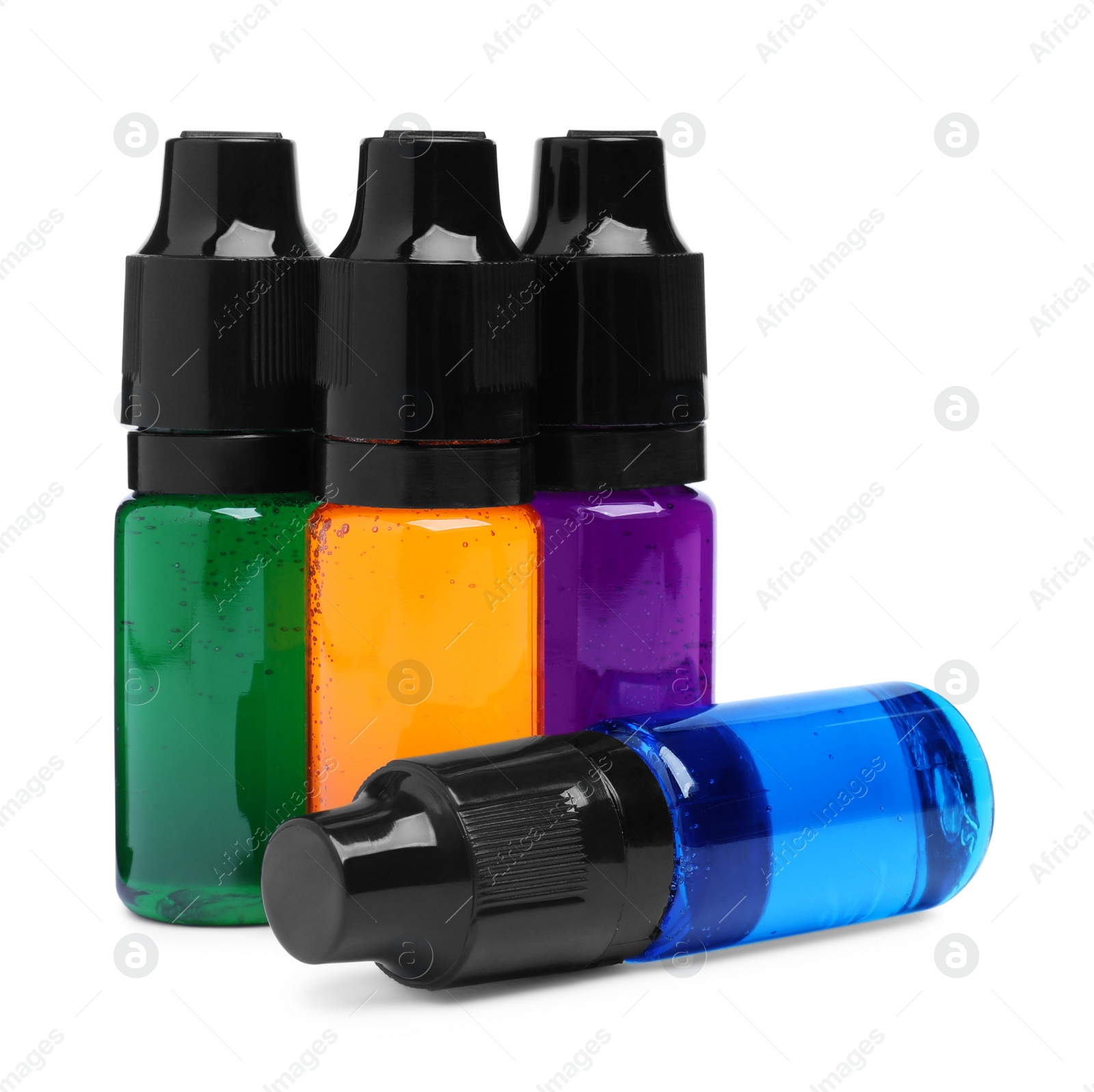 Photo of Bottles with different food coloring on white background