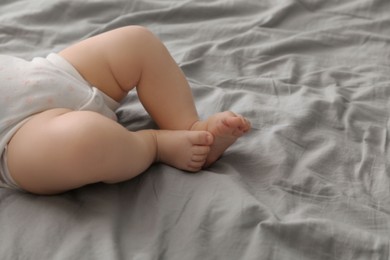 Photo of Little baby on bed, closeup. Space for text
