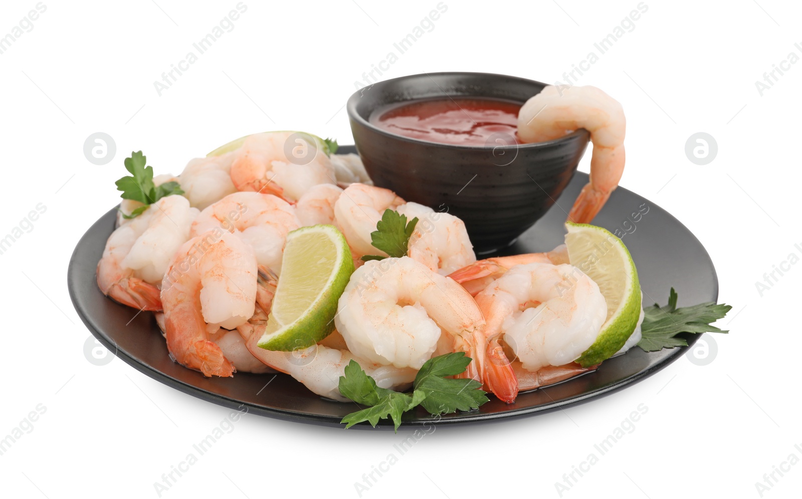 Photo of Tasty boiled shrimps with cocktail sauce, lime and parsley isolated on white