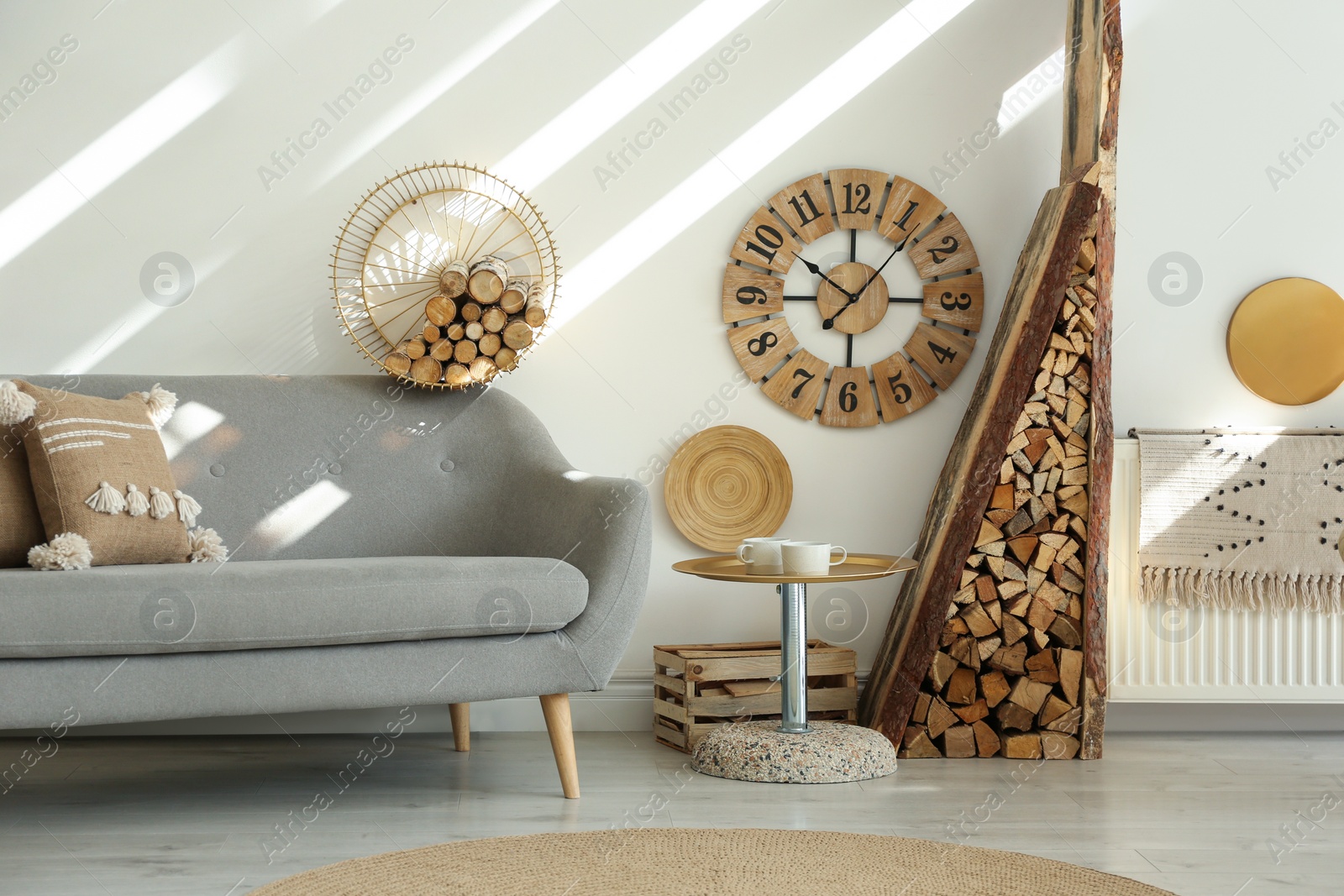 Photo of Stylish room interior with firewood as decorative element