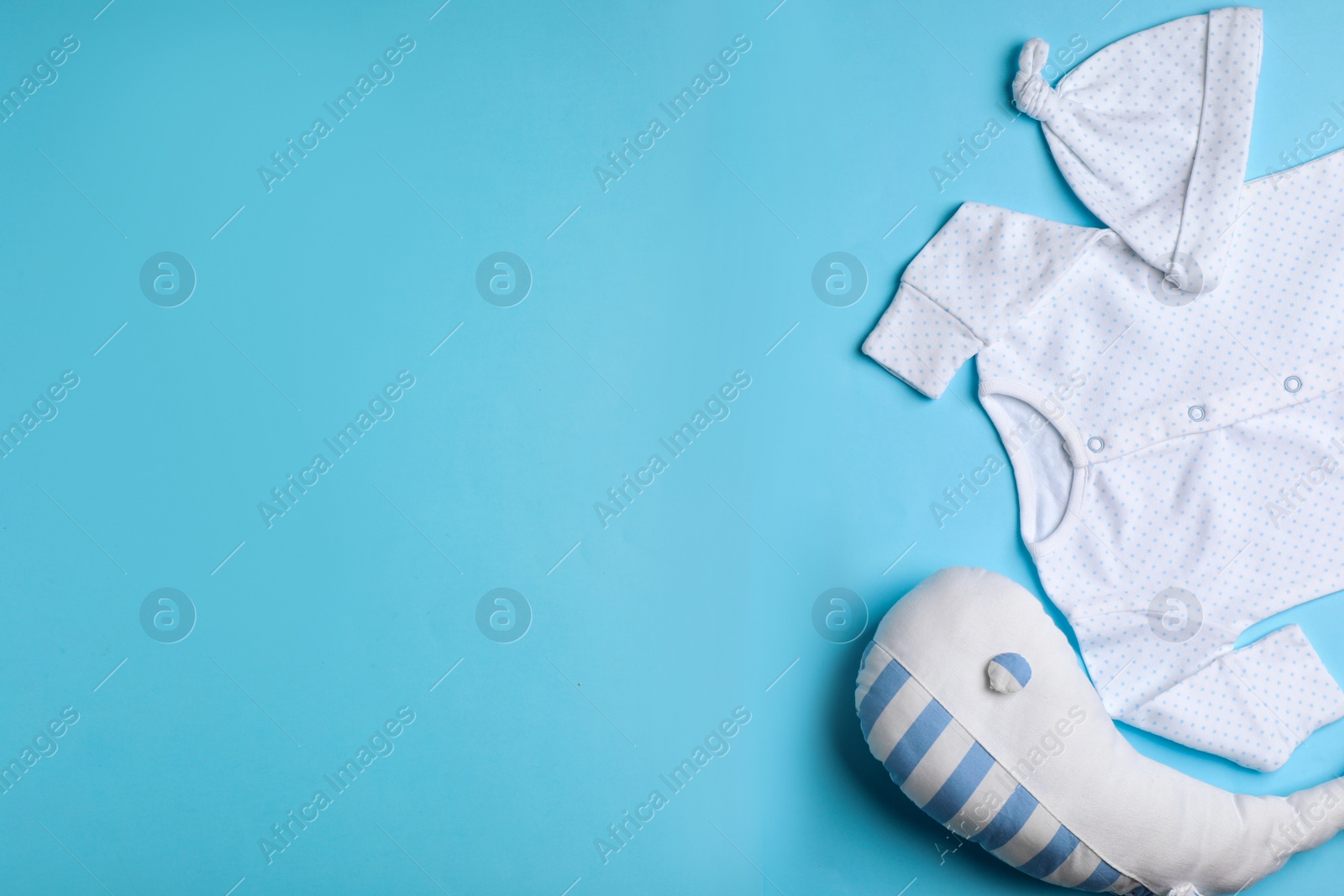 Photo of Flat lay composition with clothes and space for text on color background. Baby accessories