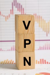 Photo of Acronym VPN (Virtual Private Network) made of wooden cubes on document