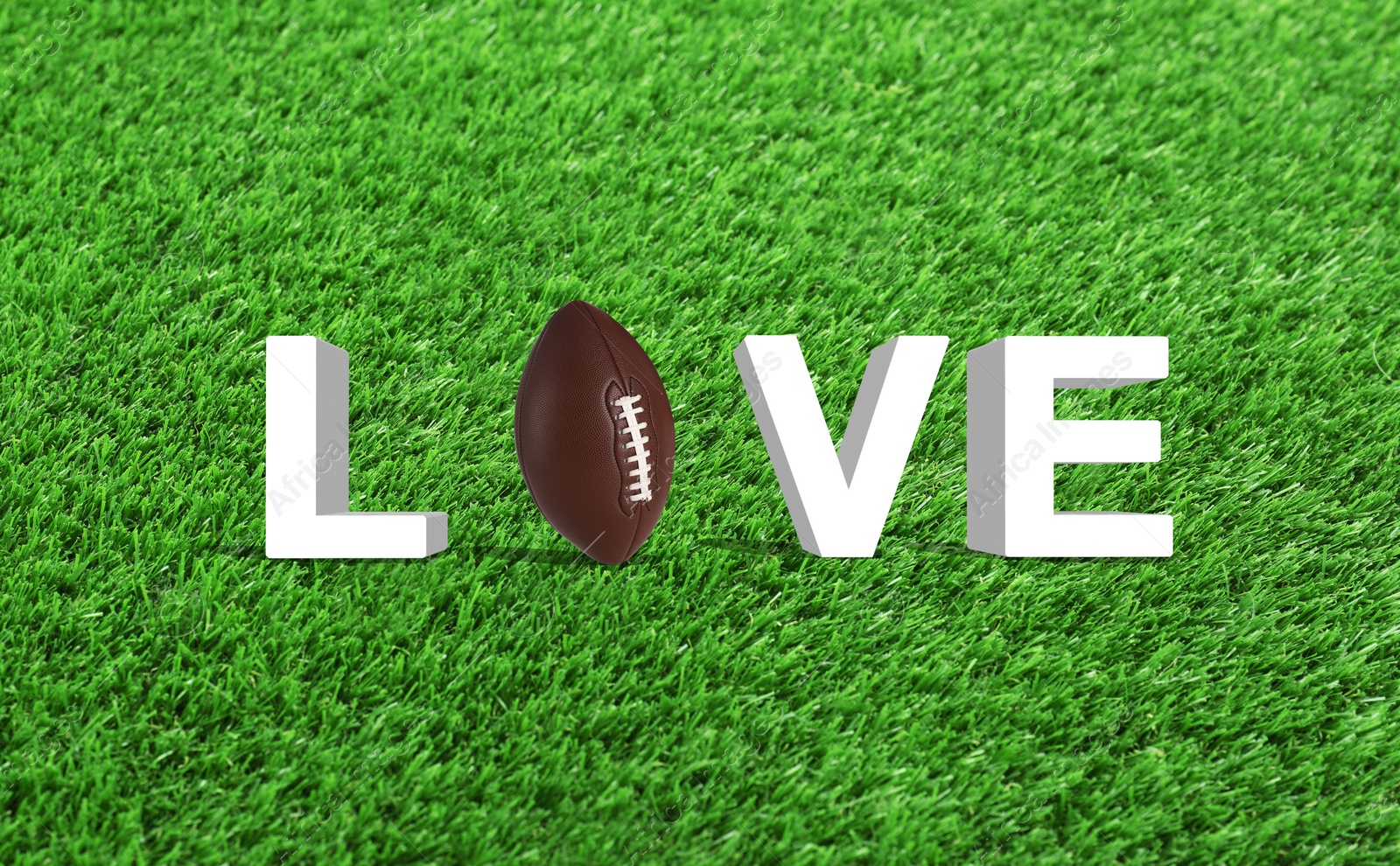 Image of Word LOVE made of letters and football ball on green grass