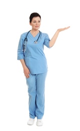 Photo of Full length portrait of female doctor in scrubs isolated on white. Medical staff