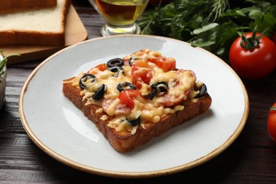 Photo of Tasty pizza toast and products on wooden table