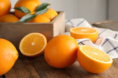 Photo of Fresh juicy oranges on wooden table. Healthy fruits