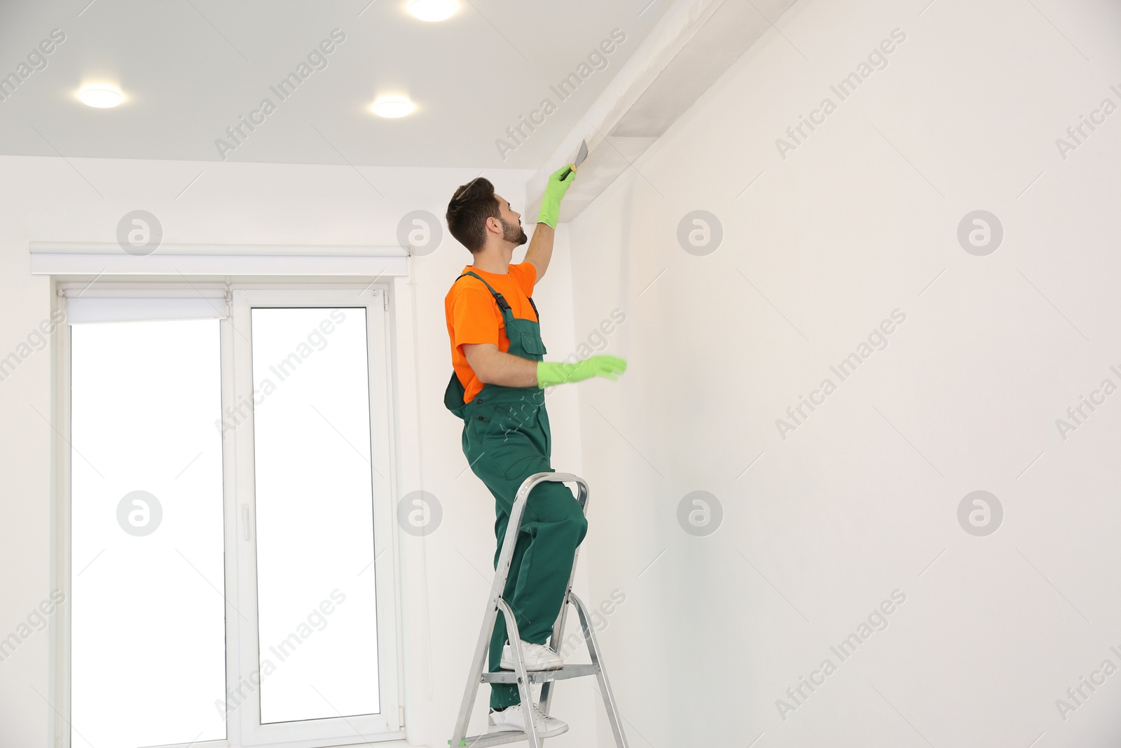 Photo of Professional young janitor in uniform. Cleaning service