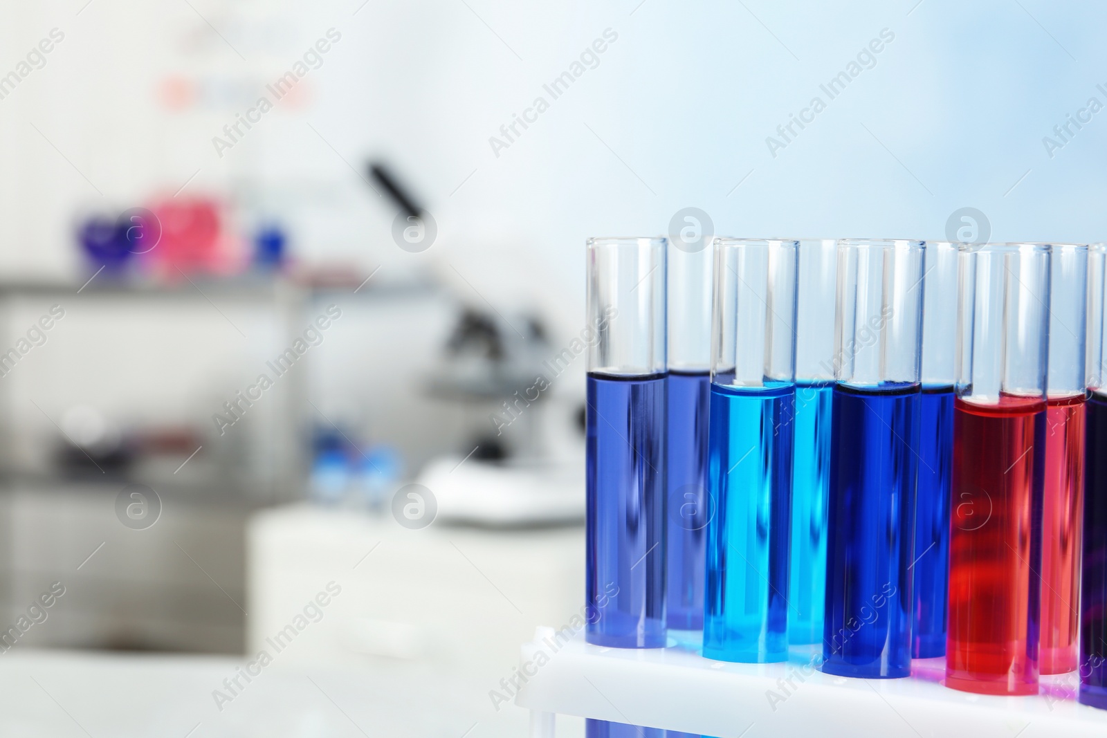 Photo of Test tubes with samples in chemistry laboratory, closeup. Space for text