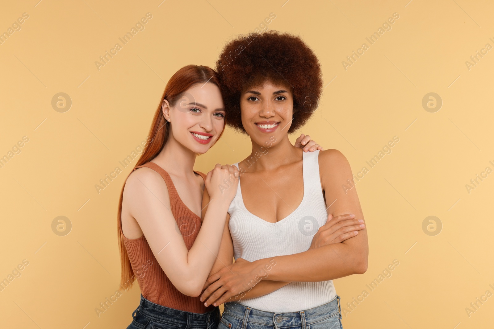 Photo of Portrait of beautiful young women on beige background