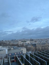 Photo of Beautiful buildings in Paris on cloudy day, view from hotel window