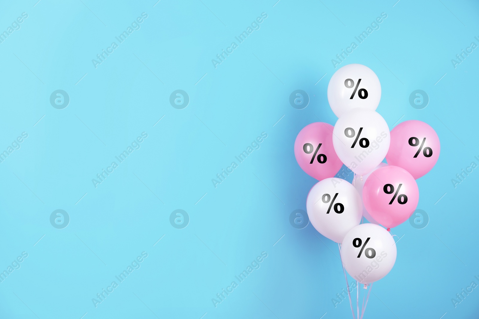 Image of Discount offer. Balloons with percent sign on light blue background, space for text