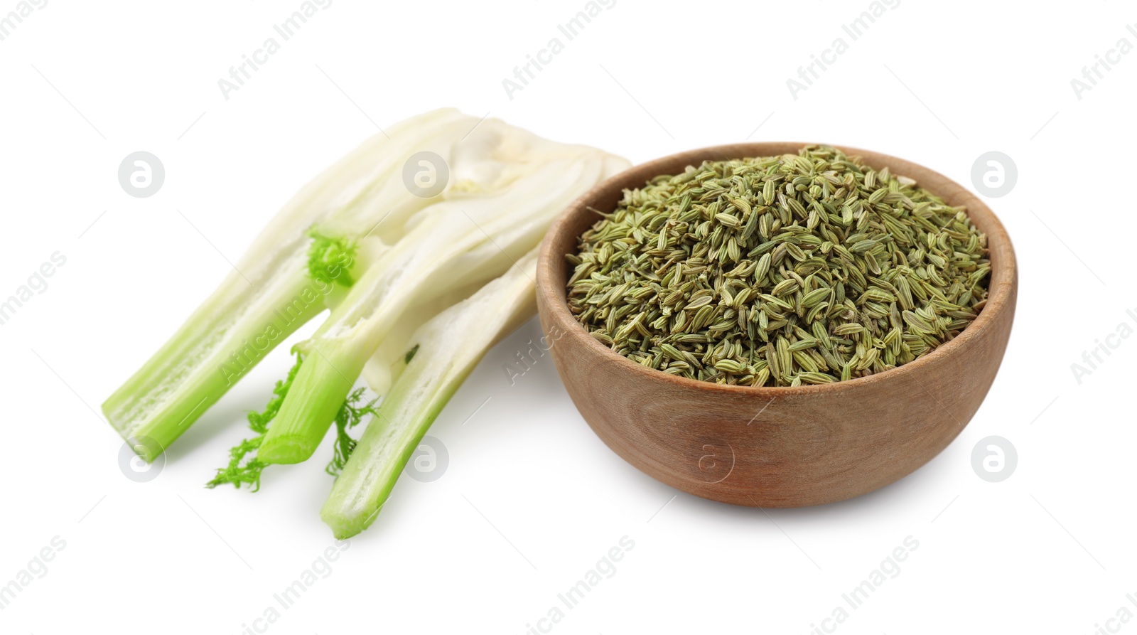 Photo of Fennel bulb and seeds in wooden bowl isolated on white