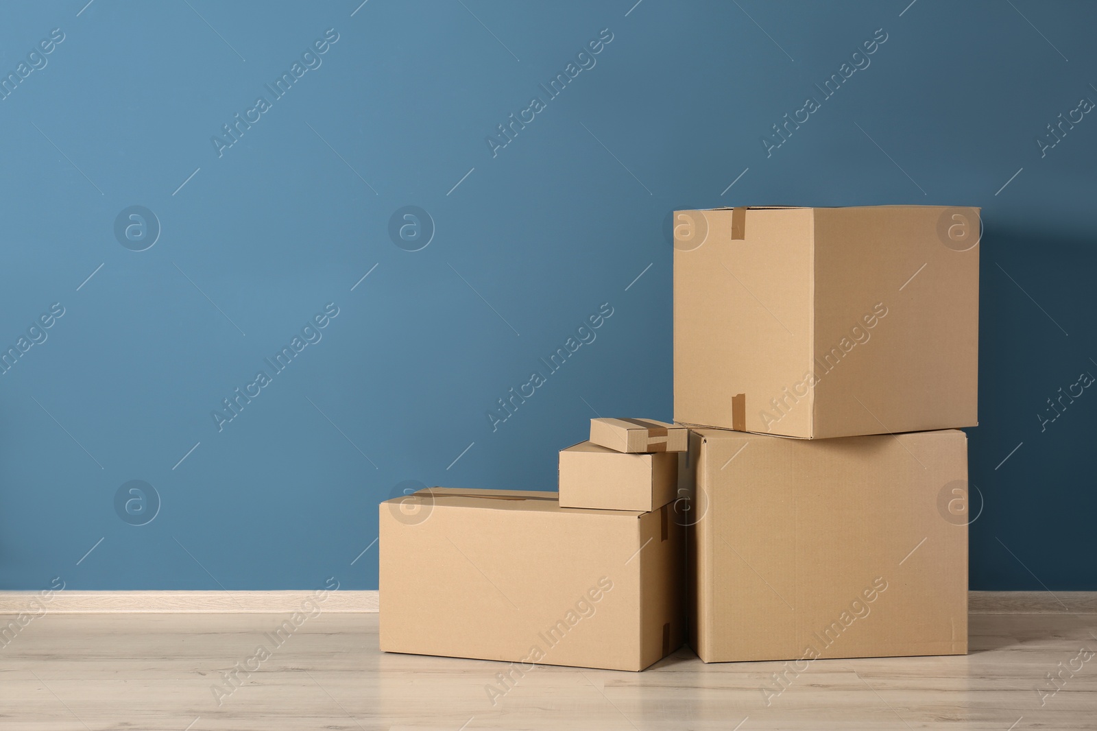 Photo of Cardboard boxes near color wall