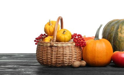 Happy Thanksgiving day. Composition with pumpkins, walnuts and berries on black wooden table. Space for text