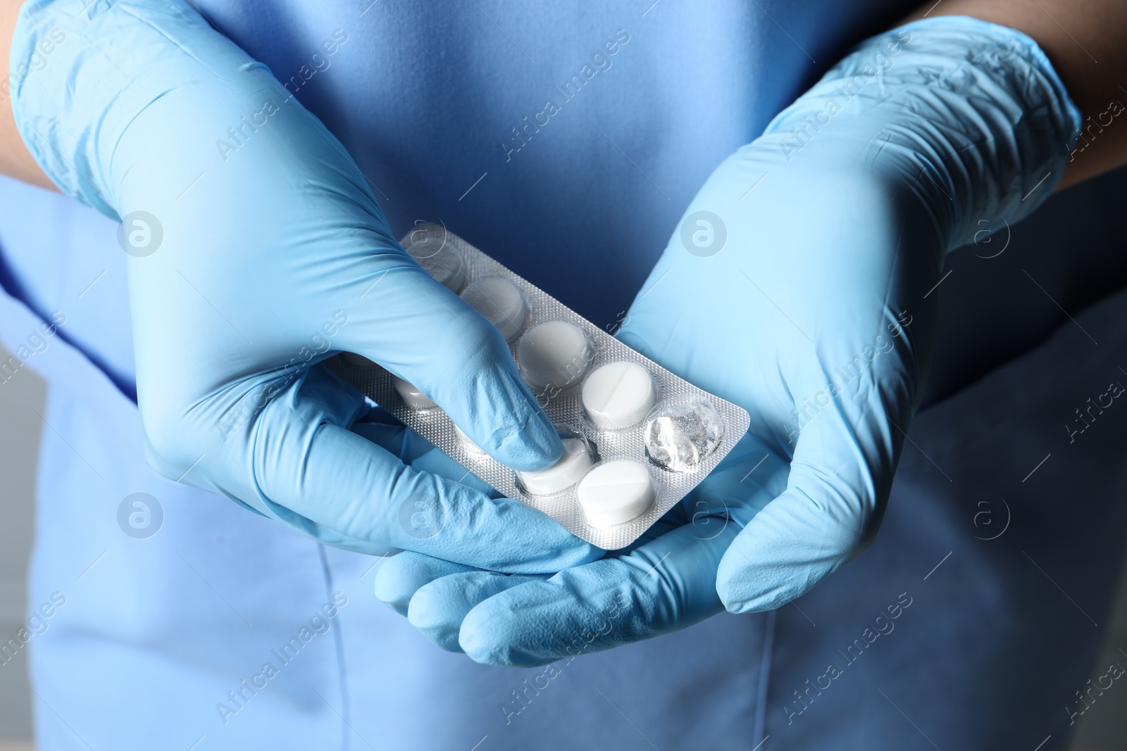 Photo of Doctor taking pill out from blister pack, closeup