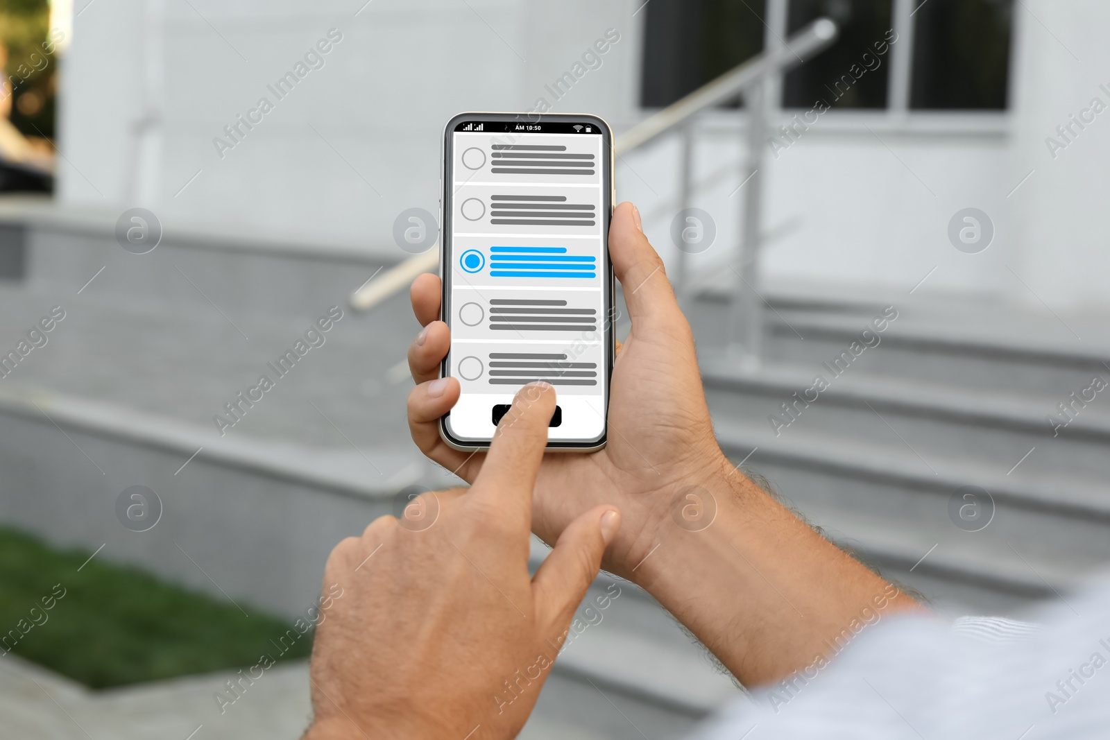 Image of Man voting online via smartphone outdoors, closeup