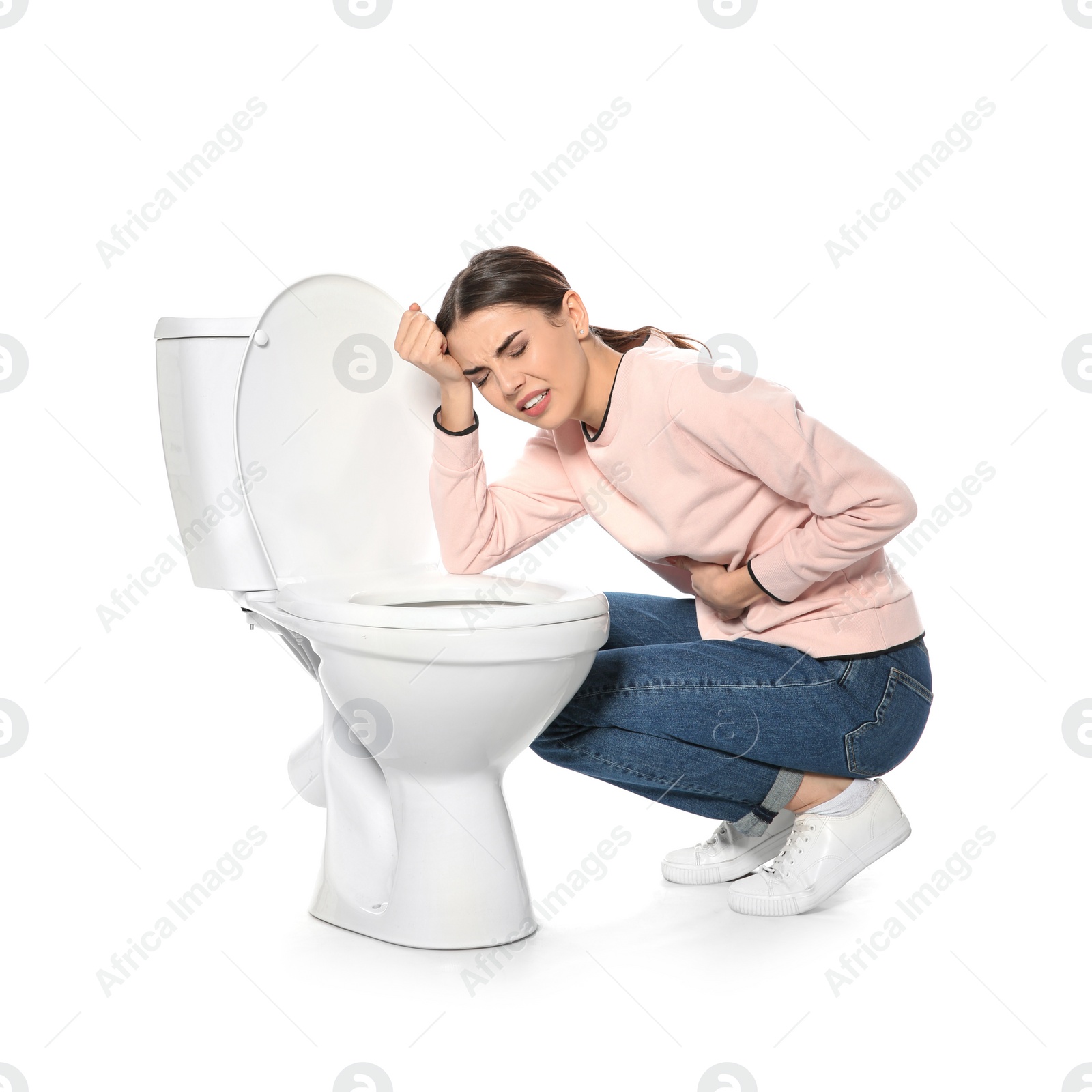 Photo of Young woman suffering from nausea near toilet bowl isolated on white