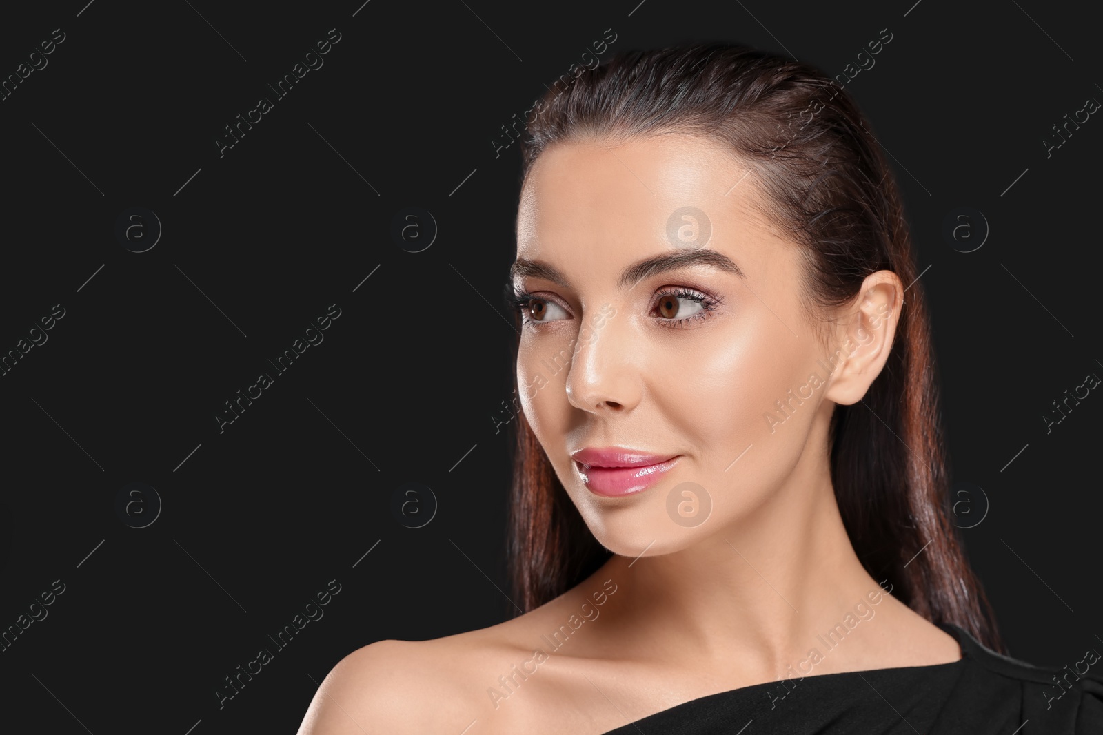 Photo of Portrait of young woman with beautiful makeup on black background. Space for text