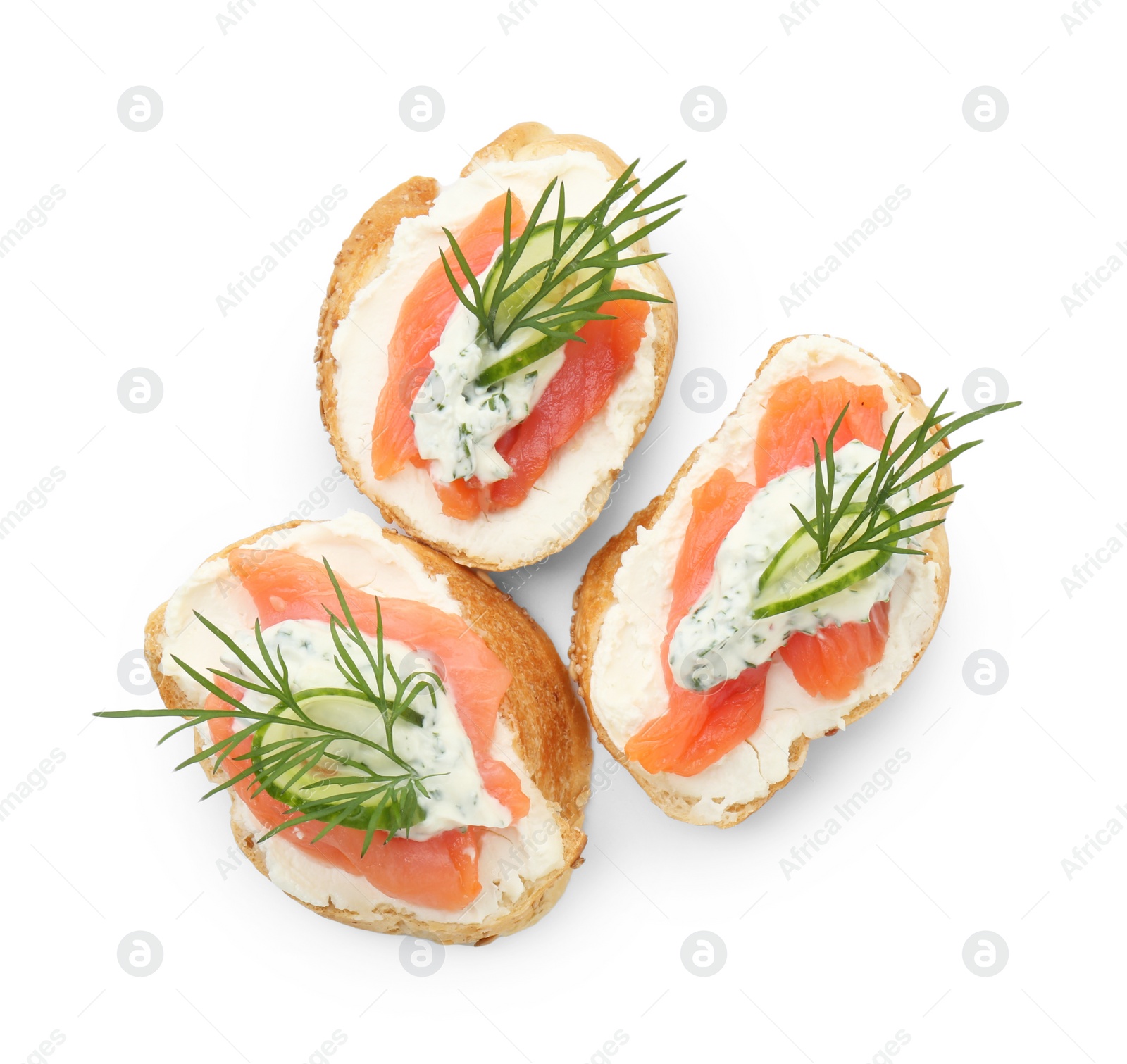 Photo of Tasty canapes with salmon, cucumber, cream cheese and dill isolated on white, top view