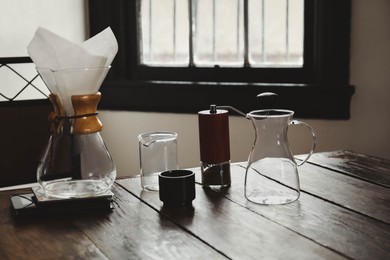 Photo of Dishware for coffee making on wooden table in cafe