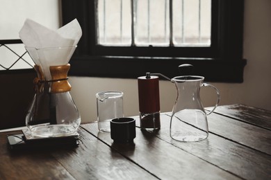 Dishware for coffee making on wooden table in cafe